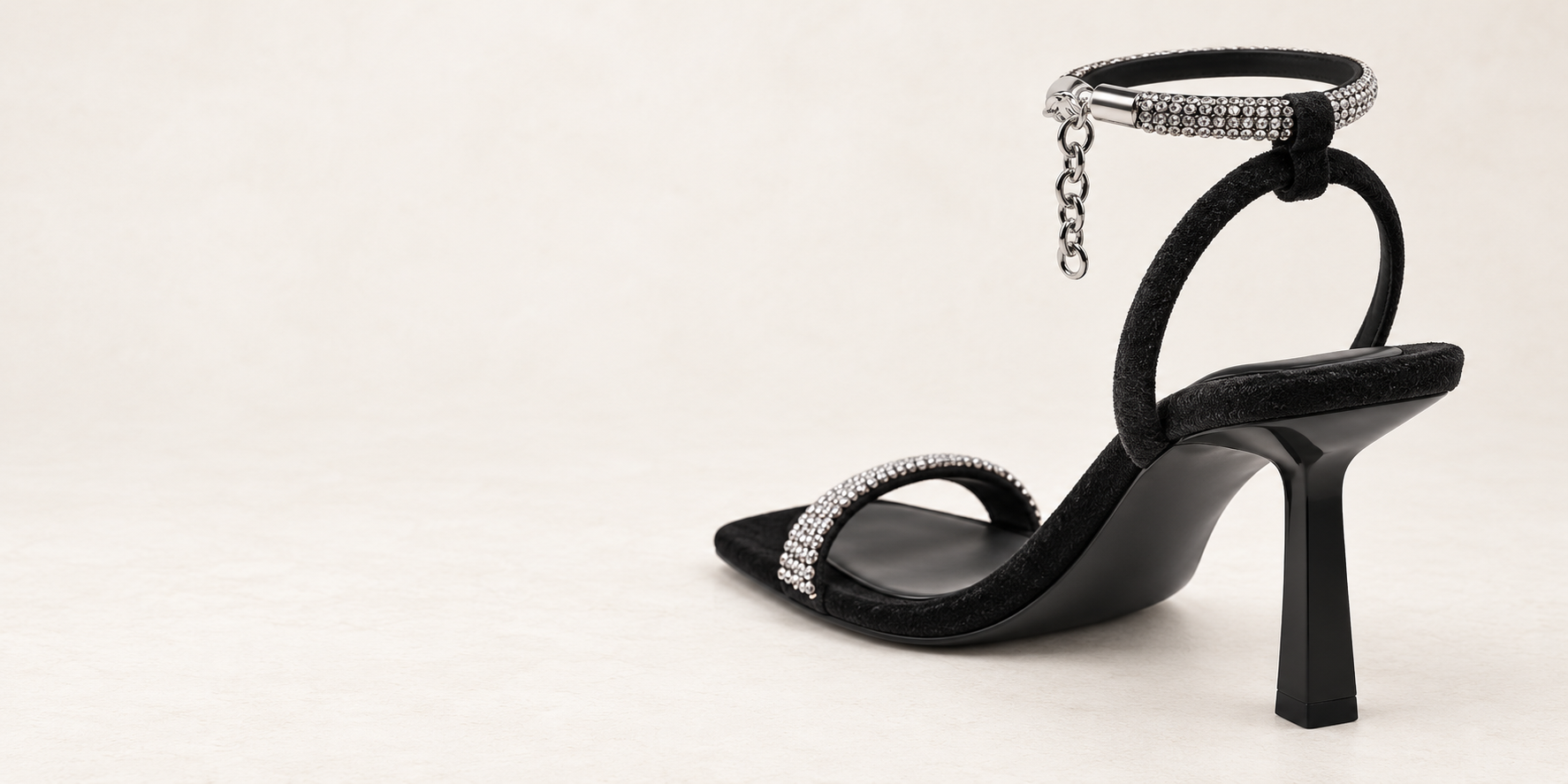 Rear three-quarter view of the sandal and its rhinestone ankle strap.